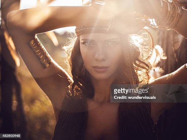 beautiful wild girl portrait in golden sun flare - spirituality stock pictures, royalty-free photos & images