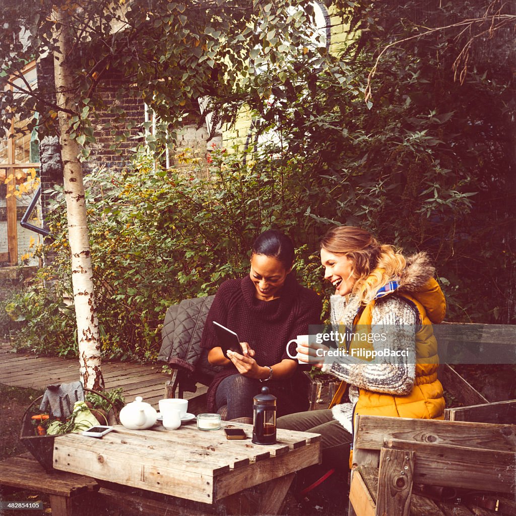 Two Friends Take Tea In The Garden