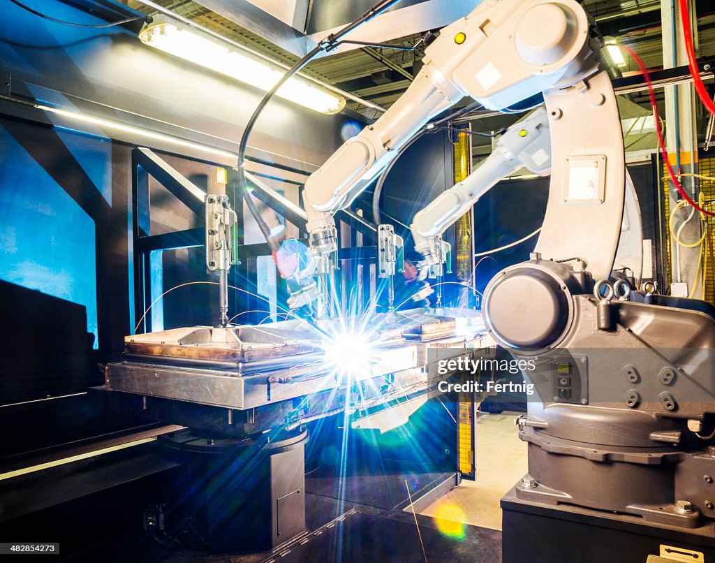 High tech robotic welder in modern metal factory