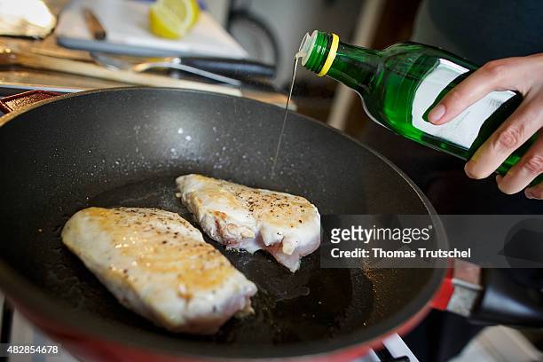 On May 25: Rapeseed oil is poured from a bottle in a frying pan with poultrymeat .