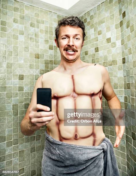 selfie in the bathroom with fake muscles - nerd workout stock pictures, royalty-free photos & images