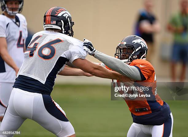 Denver Broncos long snapper Aaron Brewer and Denver Broncos defensive back Josh Bush runs through drills during practice on day 4 of training camp...