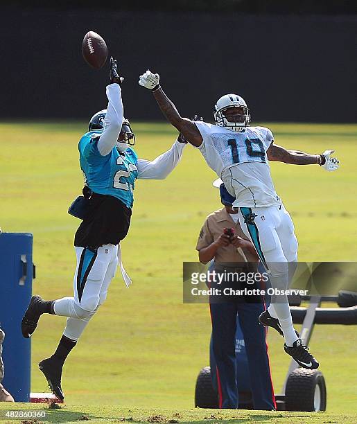 Carolina Panthers cornerback Melvin White, left, breaks up a pass meant for wide receiver Ted Ginn, Jr., right, during practice on Monday, August 3,...