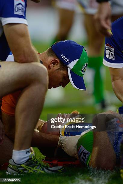 Joel Edwards of the Raiders receives treatment from trainers after a heavy hit during the round five NRL match between the Penrith Panthers and...