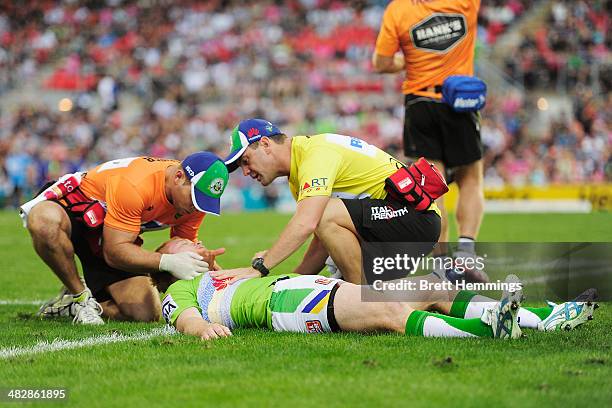 Joel Edwards of the Raiders receives treatment from trainers after a heavy hit during the round five NRL match between the Penrith Panthers and...