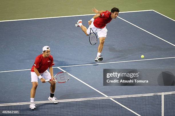 Tatsuma Ito and Yasutaka Uchiyama of Japan in action during their doubles match against Radek Stepanek and Lukas Rosol of Czech Republic during day...