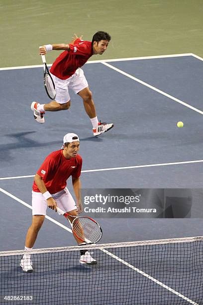 Tatsuma Ito and Yasutaka Uchiyama of Japan in action during their doubles match against Radek Stepanek and Lukas Rosol of Czech Republic during day...