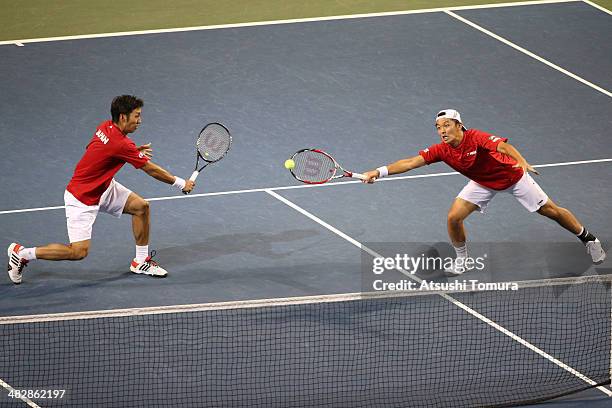 Tatsuma Ito and Yasutaka Uchiyama of Japan in action during their doubles match against Radek Stepanek and Lukas Rosol of Czech Republic during day...