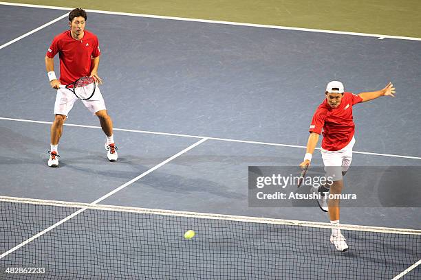 Tatsuma Ito and Yasutaka Uchiyama of Japan in action during their doubles match against Radek Stepanek and Lukas Rosol of Czech Republic during day...