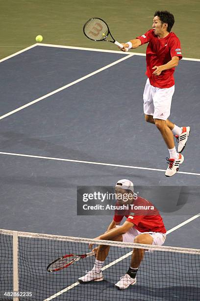 Tatsuma Ito and Yasutaka Uchiyama of Japan in action during their doubles match against Radek Stepanek and Lukas Rosol of Czech Republic during day...