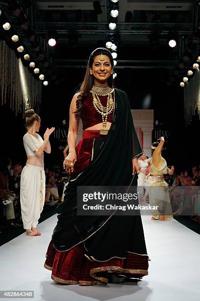 Juhi Chawla walks the runway at the Tanishq show during Day 1 of the India International Jewellery Week at the Grand Hyatt on August 3, 2015 in...