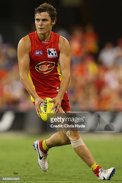 Kade Kolodjashnij of the Suns kicks during the round three AFL match between the Gold Coast Suns and the Brisbane Lions at Metricon Stadium on April...