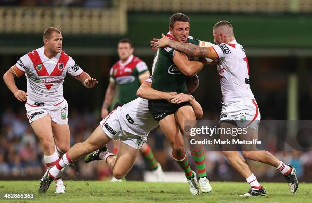 Sam Burgess of the Rabbitohs is tackled during the round five NRL match between the St George Illawarra Dragons and the South Sydney Rabbitohs at...