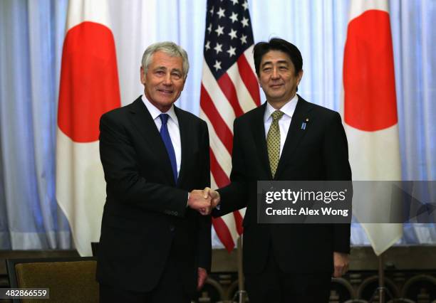 Secretary of Defense Chuck Hagel shakes hands with Japanese Prime Minister Shinzo Abe during a meeting on April 5, 2014 at the prime minister's...