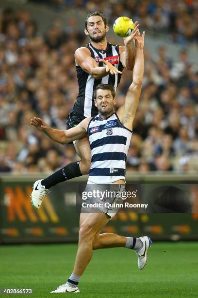 Brodie Grundy of the Magpies attempts to mark over the top of Jared Rivers of the Cats during the round three AFL match between the Collingwood...