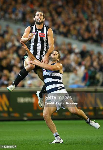 Brodie Grundy of the Magpies flies for a mark over the top of Jared Rivers of the Cats during the round three AFL match between the Collingwood...