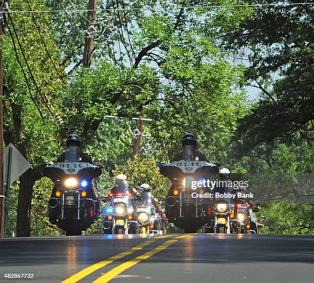 Police escort a hearse carrying the body of Bobbi Kristina Brown at Fairview Cemetery on August 3, 2015 in Westfield, New Jersey. Bobbi Kristina...