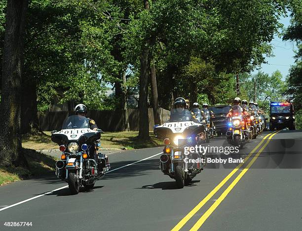 Police escort a hearse carrying the body of Bobbi Kristina Brown at Fairview Cemetery on August 3, 2015 in Westfield, New Jersey. Bobbi Kristina...