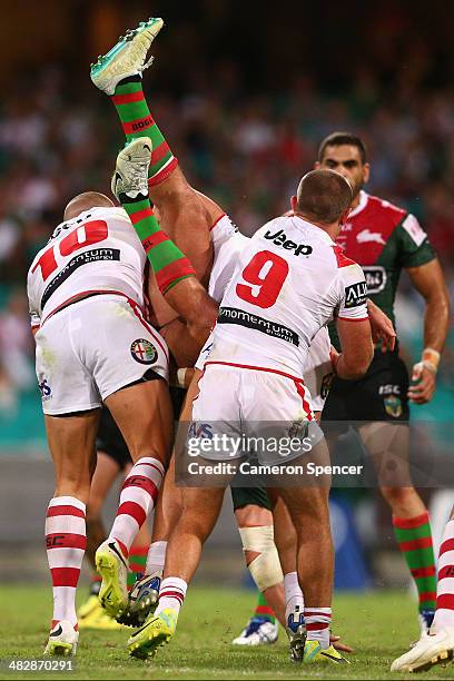 Sam Burgess of the Rabbitohs is tackled during the round five NRL match between the St George Illawarra Dragons and the South Sydney Rabbitohs at...