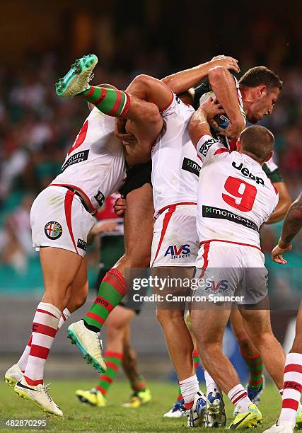Sam Burgess of the Rabbitohs is tackled during the round five NRL match between the St George Illawarra Dragons and the South Sydney Rabbitohs at...