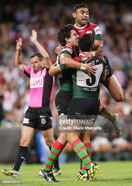 Joel Reddy of the Rabbitohs celebrates with team mates Nathan Merritt and Dylan Walker for a try that was disallowed during the round five NRL match...