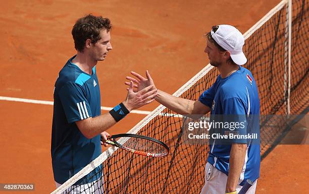 Andy Murray of Great Britain shakes hands at the net after his straight sets victory over against Andreas Seppi of Italy in the second rubber during...