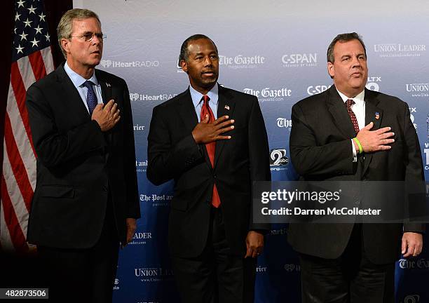 Former Florida Gov. Jeb Bush, Dr. Ben Carson,\ and New Jersey Gov. Chris Christie stand on the stage prior to the Voters First Presidential Forum for...