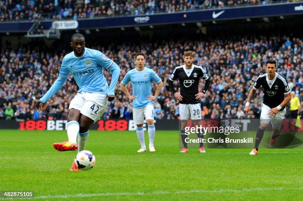 Yaya Toure of Manchester City scores the opening goal from the penalty spot during the Barclays Premier League match between Manchester City and...