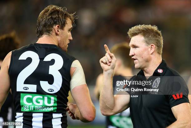 Nathan Buckley the coach of the Magpies talks to Lachlan Keeffe of the Magpies during the round three AFL match between the Collingwood Magpies and...