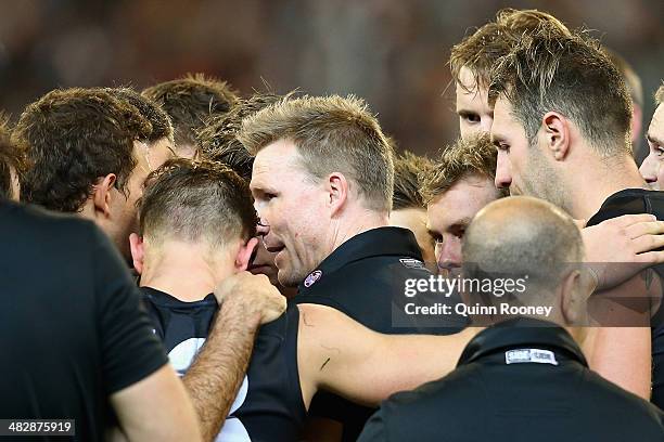 Nathan Buckley the coach of the Magpies talks to his players during the round three AFL match between the Collingwood Magpies and the Carlton Blues...