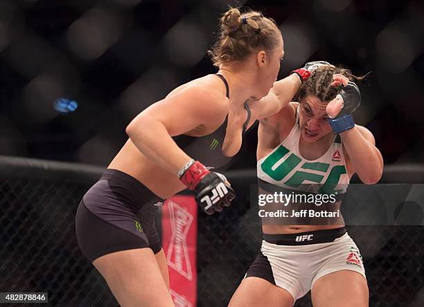 Women's bantamweight champion Ronda Rousey punches Bethe Correia of Brazil during the UFC 190 event inside HSBC Arena on August 1, 2015 in Rio de...