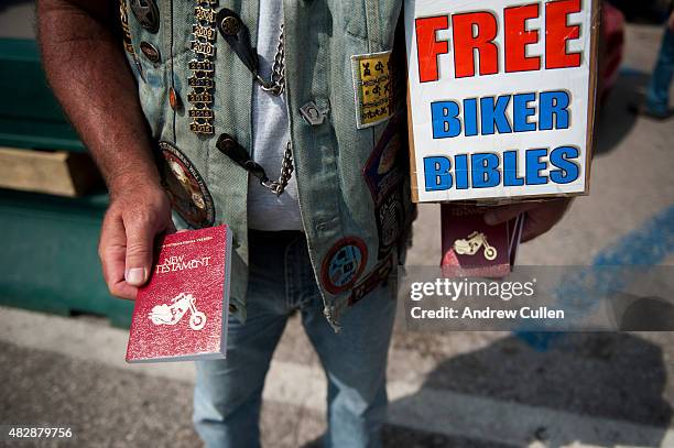 Dan Lawrence hands out free copies of the New Testament downtown on the first day of the annual Sturgis Motorcycle Rally August 3, 2015 in Sturgis,...