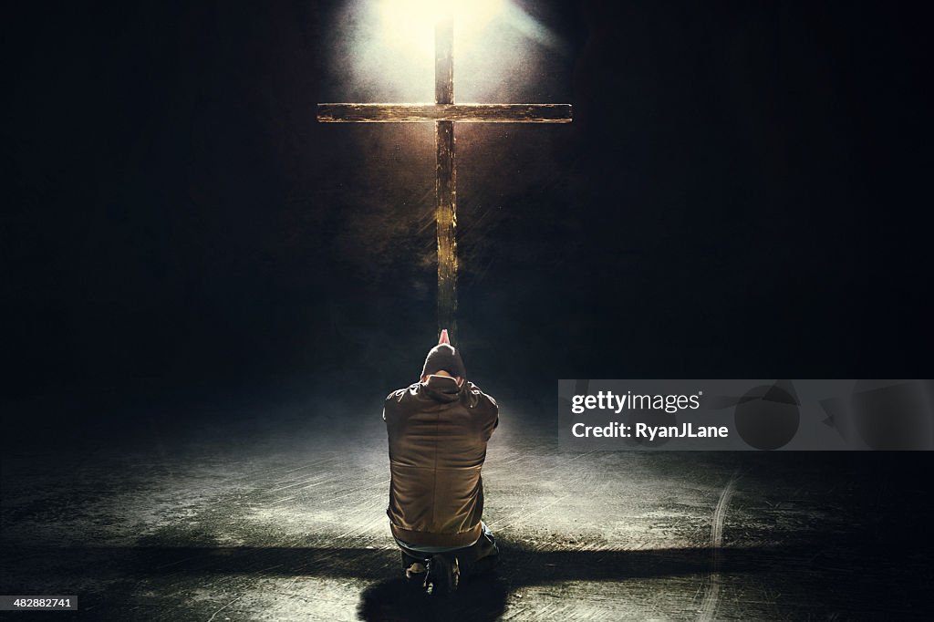 Man Kneeling Before the Cross