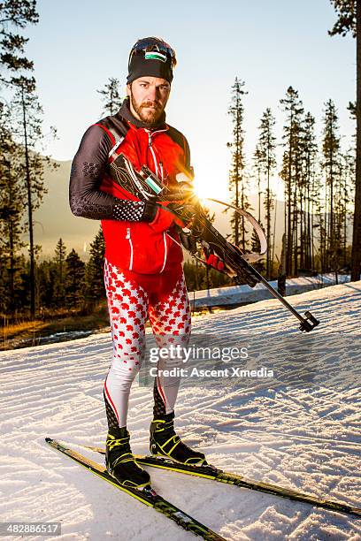 biathlete trains on mountain trail, in snow - biathlon ski stock pictures, royalty-free photos & images