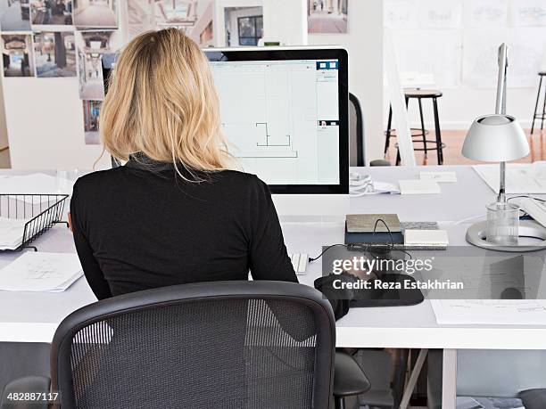 female designer works on computer - designer ストックフォトと画像