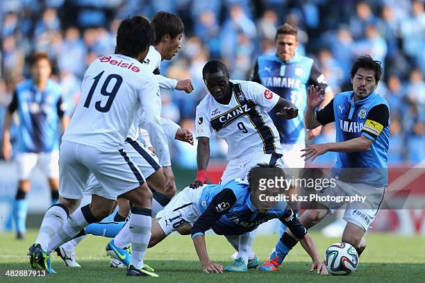 Ryoichi Maeda of Jubilo Iwata is tacled by Thespa Kusatsu Gunma players during the J.League second division match between Jubilo Iwata and Thespa...