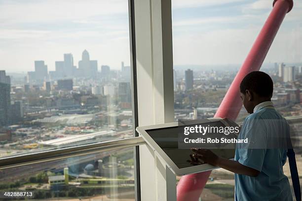 Boy uses an interactive device at the top of the 114.5 metre high ArcelorMittal Orbit tower at the Olympic Park on April 5, 2014 in London, England....