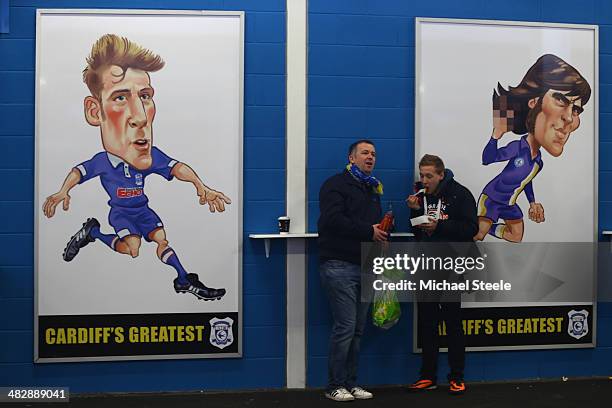 Supporters of Cardiff City have pre match refreshments alongside posters of City legends Karl Dale and Robin Friday ahead of the Barclays Premier...