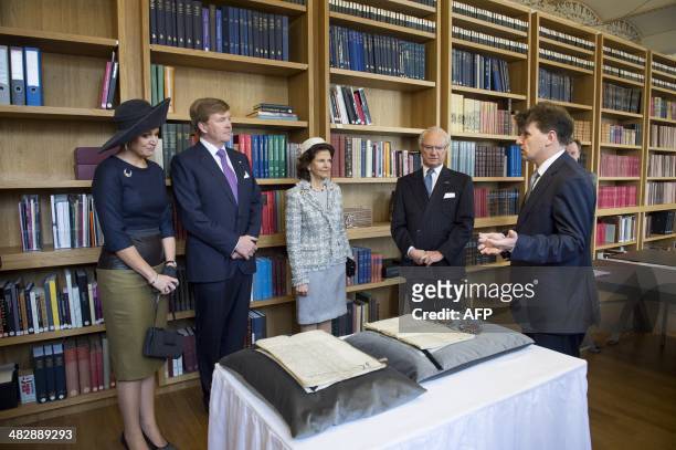 Dutch Queen Maxima, Dutch King Willem-Alexander, Swedish Queen Silvia and Swedish King Carl Gustaf listen to the director of the National Archive...