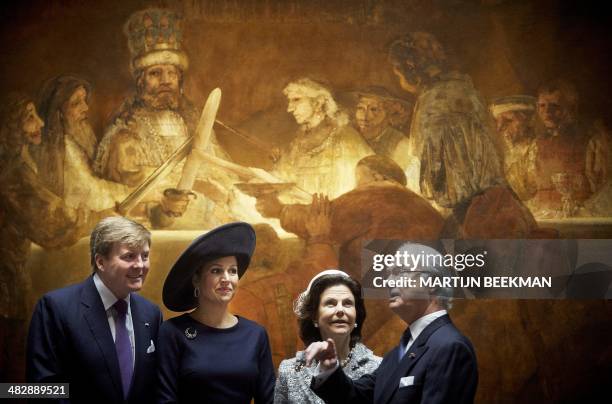Dutch King Willem-Alexander, Dutch Queen Maxima, Swedish King Carl Gustaf and Swedish Queen Silvia pose in front of the painting "The Conspiracy of...