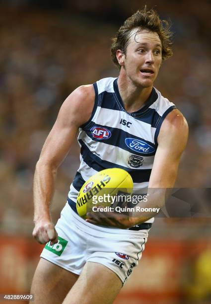 Mitch Brown of the Cats handballs during the round three AFL match between the Collingwood Magpies and the Carlton Blues at Melbourne Cricket Ground...