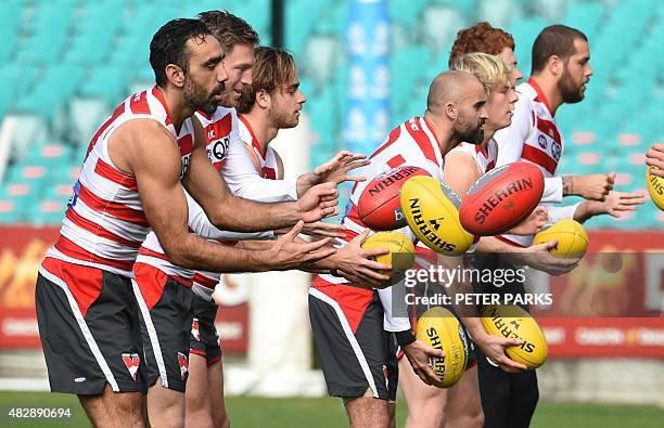 Australian Rules football star and one of Australia's most high-profile indigenous sportsmen Adam Goodes takes with his Sydney Swans teammates during...