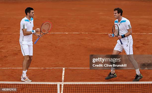 Andy Murray and Colin Fleming of Great Britain celebrate a point against Simone Bolelli and Fabio Fognini of Italy during day two of the Davis Cup...