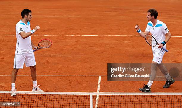 Andy Murray and Colin Fleming of Great Britain celebrate a point against Simone Bolelli and Fabio Fognini of Italy during day two of the Davis Cup...