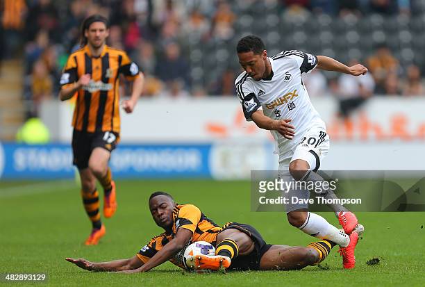 Hull City's Maynor Figueroa and Swansea City's Jonathan de Guzman compete or the ball during the Barclays Premier League match between Hull City and...