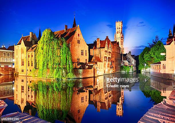 night view of belfry tower in bruges, belgium - bruges buildings stock pictures, royalty-free photos & images