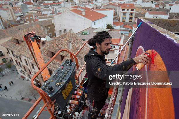 Chilean graffiti artist Inti paints a giant Don Quixote graffiti mural on a wall of a building on April 4, 2014 in Quintanar de la Orden, Spain....