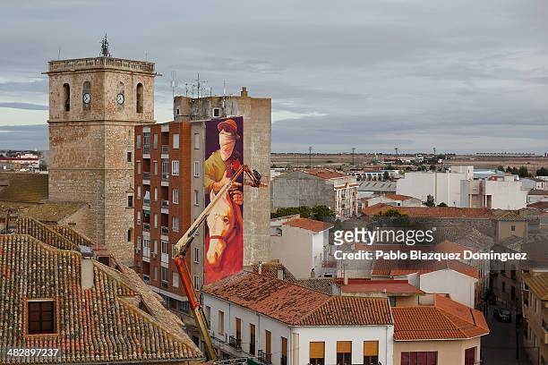 Chilean graffiti artist Inti paints a giant Don Quixote graffiti mural on a wall of a building on April 4, 2014 in Quintanar de la Orden, Spain....