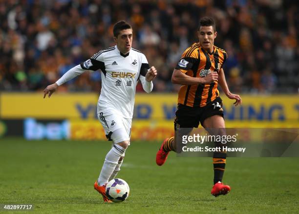 Pablo Hernandez of Swansea is pusued by Jake Livermore of Hull City during the Barclays Premier league match between Hull City and Swansea City at KC...