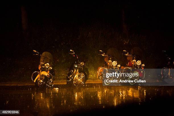 Motorcycles parked on the street sit through a late-night thunderstorm on the first day of the annual Sturgis Motorcycle Rally August 3, 2015 in...